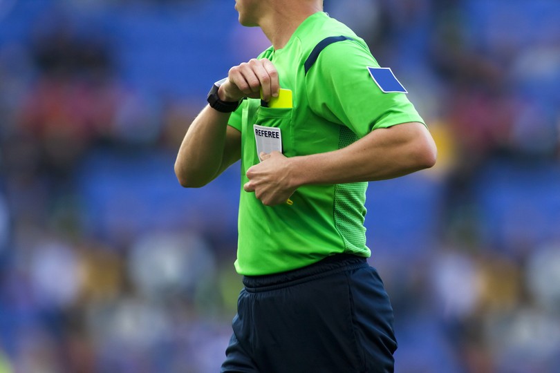 Football Referee Reaching for Yellow Card