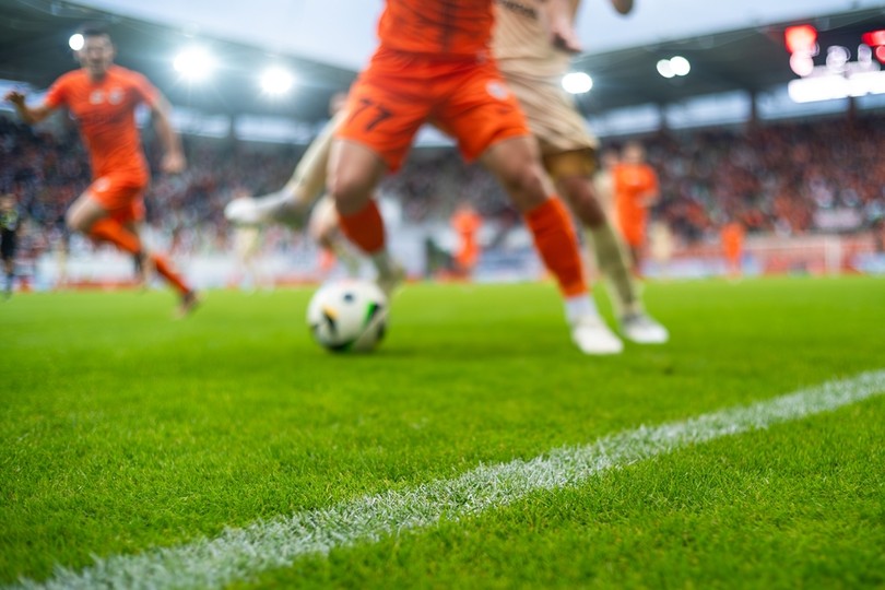 Blurred Footballers from Sidelines During Match