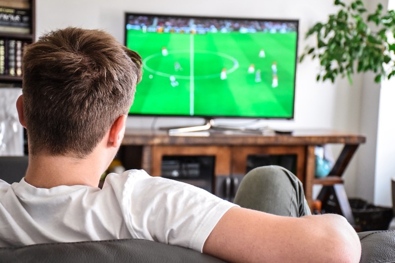 Man Watching Football Game on TV
