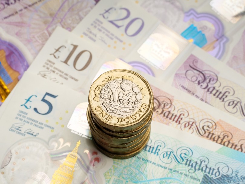 UK Banknotes with Coin Stack